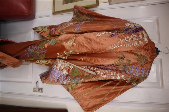 An early 20th century peach silk Japanese kimono, embroidered with polychrome silks of trailing wisteria and a similar obi